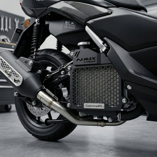 Close-up studio shot of the CustomradPH Yamaha NMAX Tech Max Radiator Cover. This black powder-coated CNC steel motorcycle accessory features an aggressive honeycomb mesh design, a precision-cut NMAX TURBO logo at the top, and a brushed metal CustomradPH badge at the bottom, showcasing its premium exterior styling and durable construction.